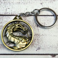 Брелок БКИМ 2009 Мортал Комбат логотип (золото антик)